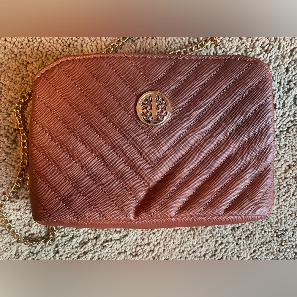 Brown purse. Gold chain. Zip inside with two button pockets